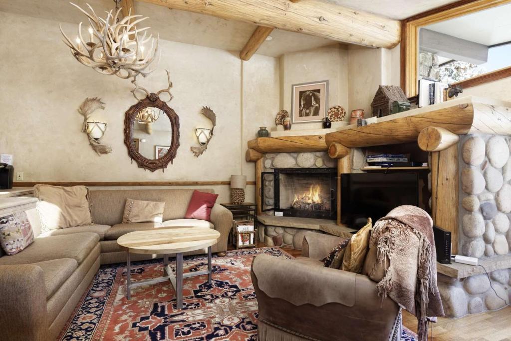 a living room with a couch and a fireplace at Shadowbrook 304 in Snowmass Village