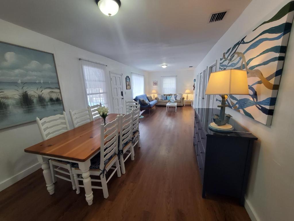 a dining room and living room with a table and chairs at La Villa Azul - A Beachy Stay in Miami in Miami