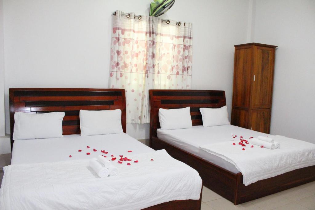 Postel nebo postele na pokoji v ubytování Ngoc May Guesthouse