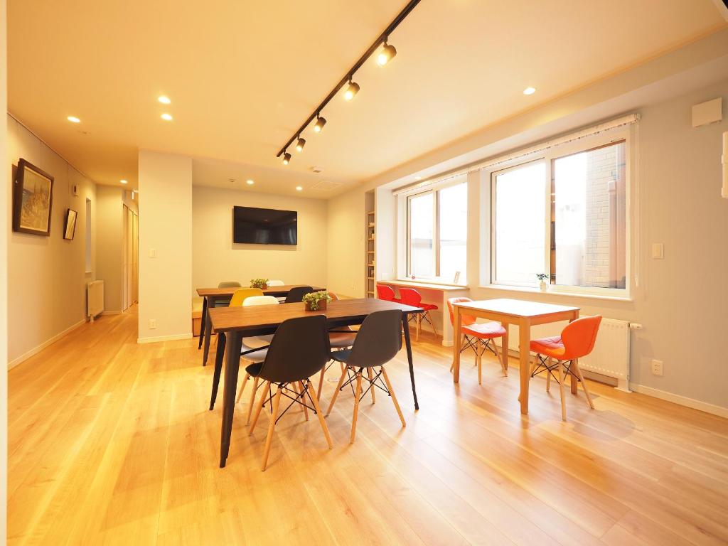 a dining room with a table and chairs at Family Tree Guest House in Sapporo