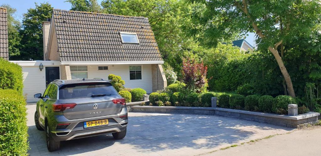 a car parked in a driveway in front of a house at Lake House 74, luxury accommodation ir Sauna in Warmond