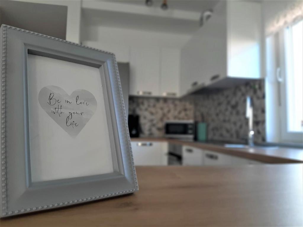 a picture in a frame on a table in a kitchen at Holiday Home Aurora in Ližnjan