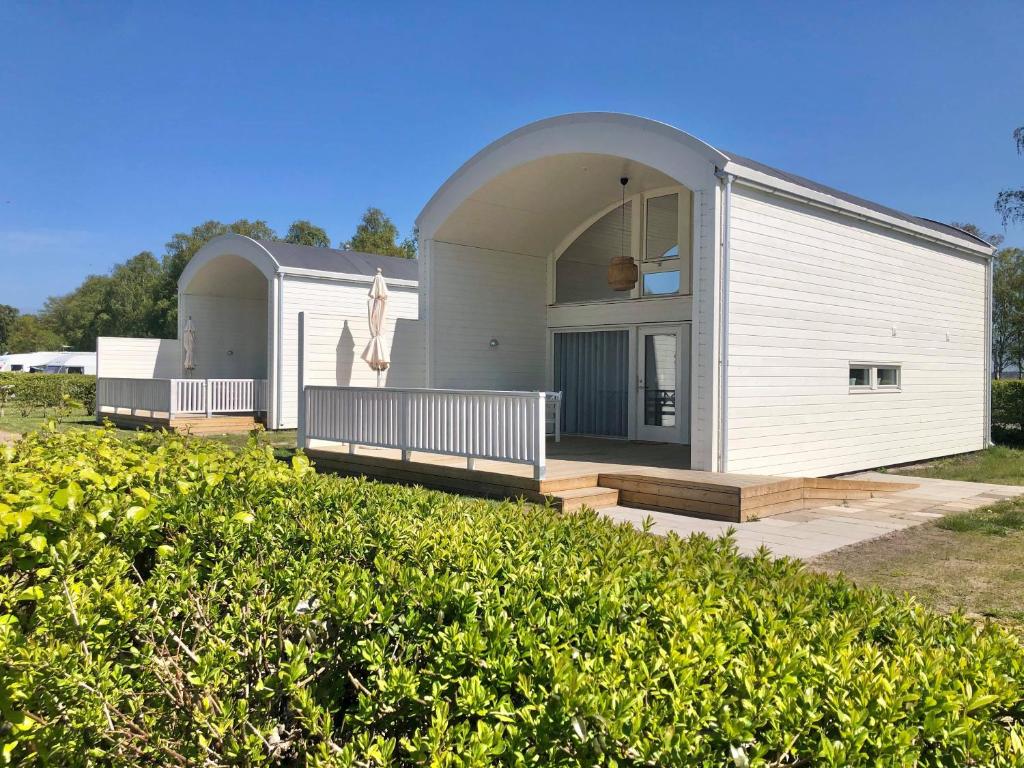 a modular home with a porch and a deck at Falsterbo Camping Resort in Skanör med Falsterbo