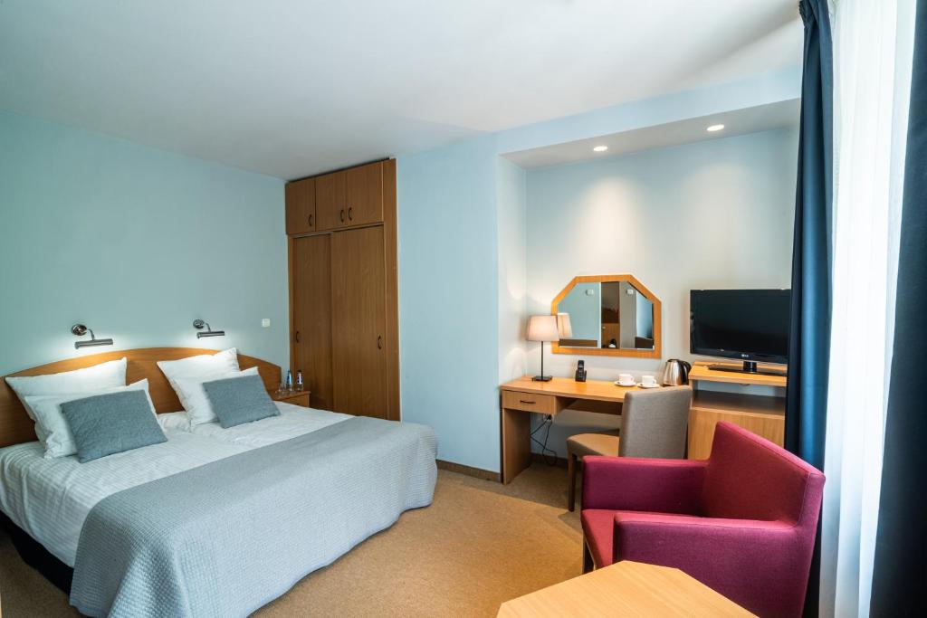 מיטה או מיטות בחדר ב-Hotel Nawigator Szczawnica