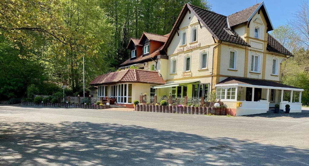 ein großes gelbes Haus mit Dach in der Unterkunft Hotel Elfenberg in Schieder-Schwalenberg