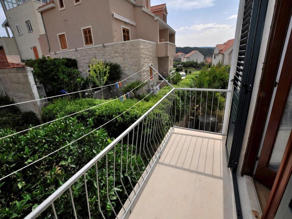 a balcony with a view of a house at Apartments Seagull in Postira