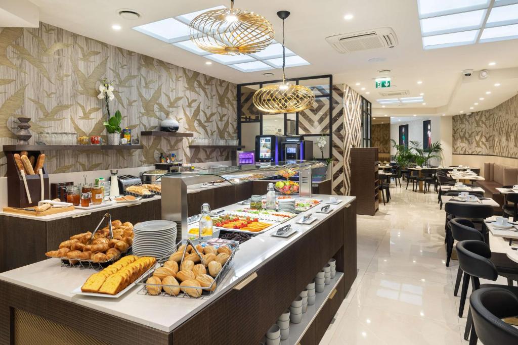 a buffet line with food on display in a restaurant at Best Western Plus Hôtel Massena Nice in Nice