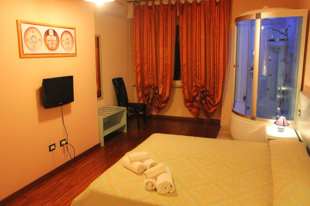 Televízia a/alebo spoločenská miestnosť v ubytovaní Bosa Guest House