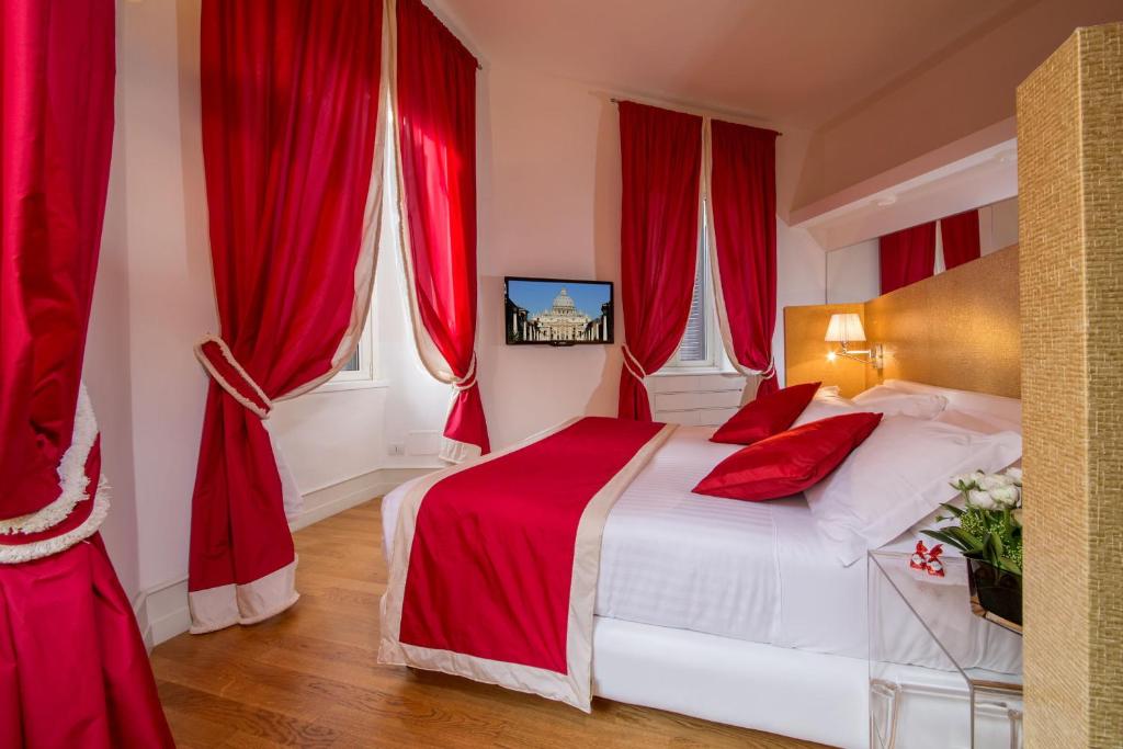 a red bedroom with a bed with red curtains at St. Peter Guest House in Rome