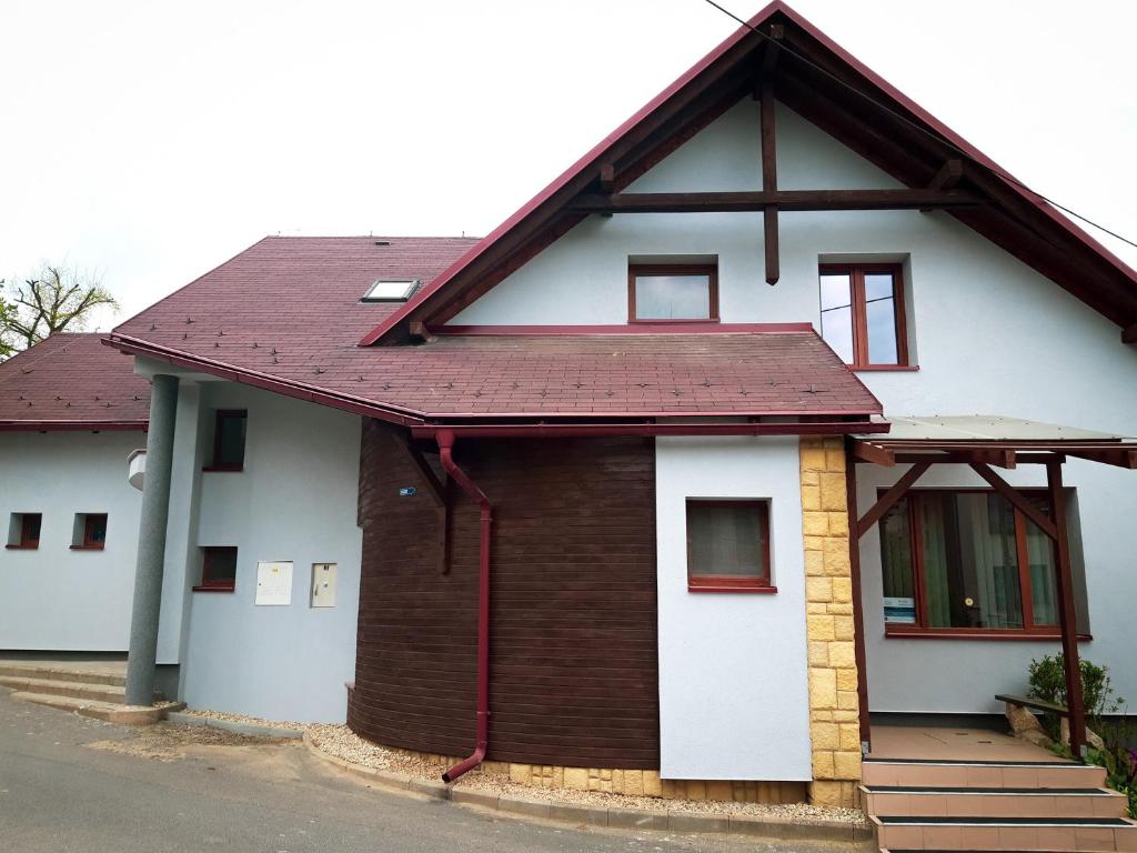 a white and brown house with a red roof at TIC Hervartov in Hervartov