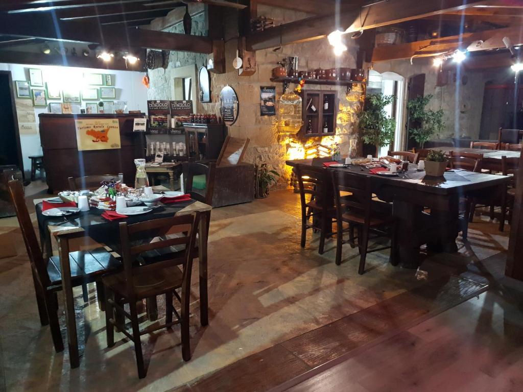 a restaurant with tables and chairs in a room at Agriturismo Leanza "La Baita" in Cesarò