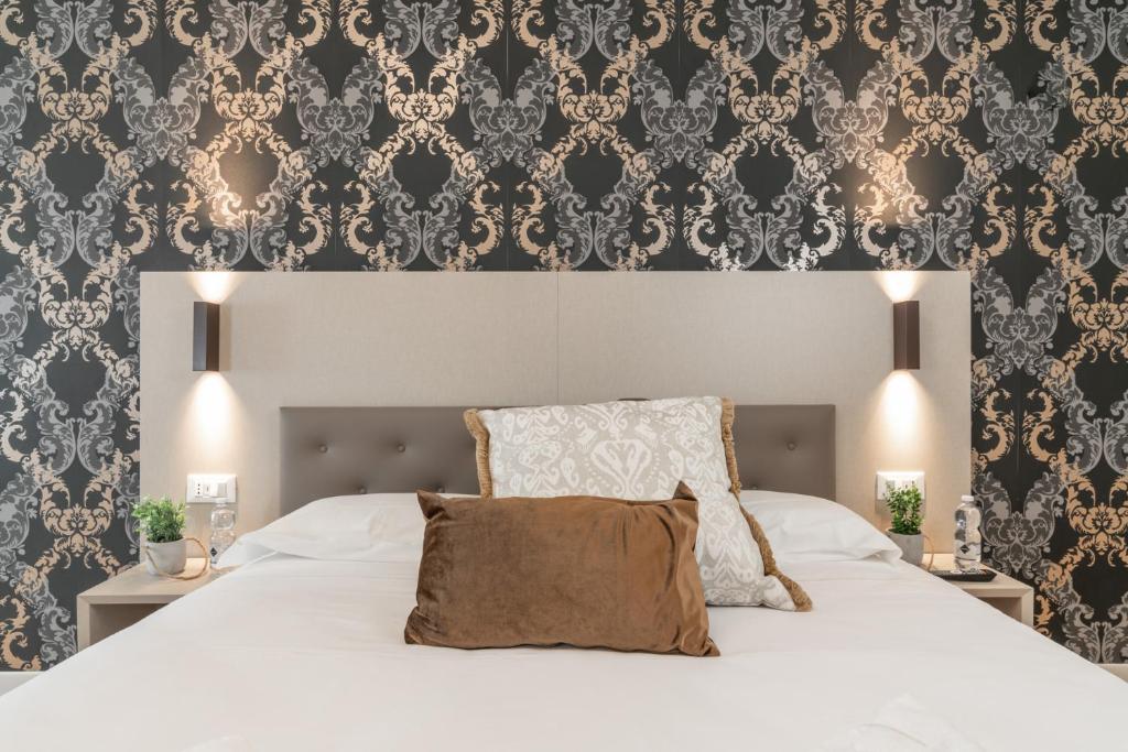 Postel nebo postele na pokoji v ubytování Hotel Grifoni