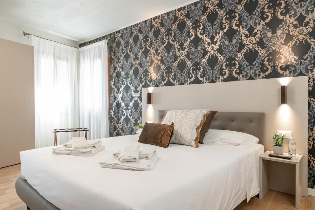 Postel nebo postele na pokoji v ubytování Hotel Grifoni