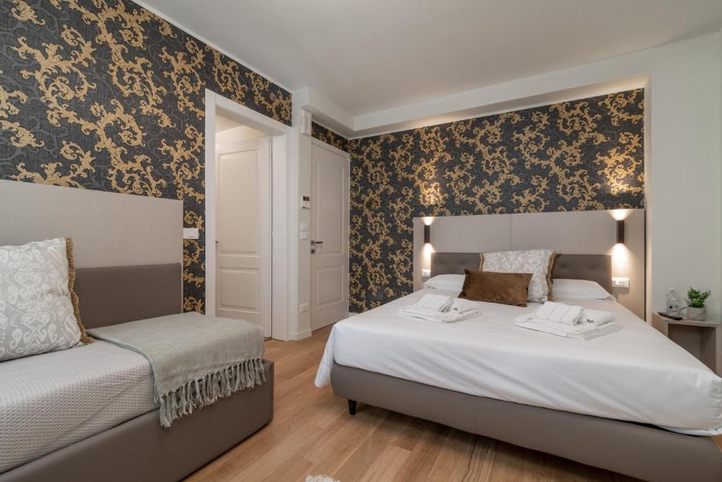 Postel nebo postele na pokoji v ubytování Hotel Grifoni