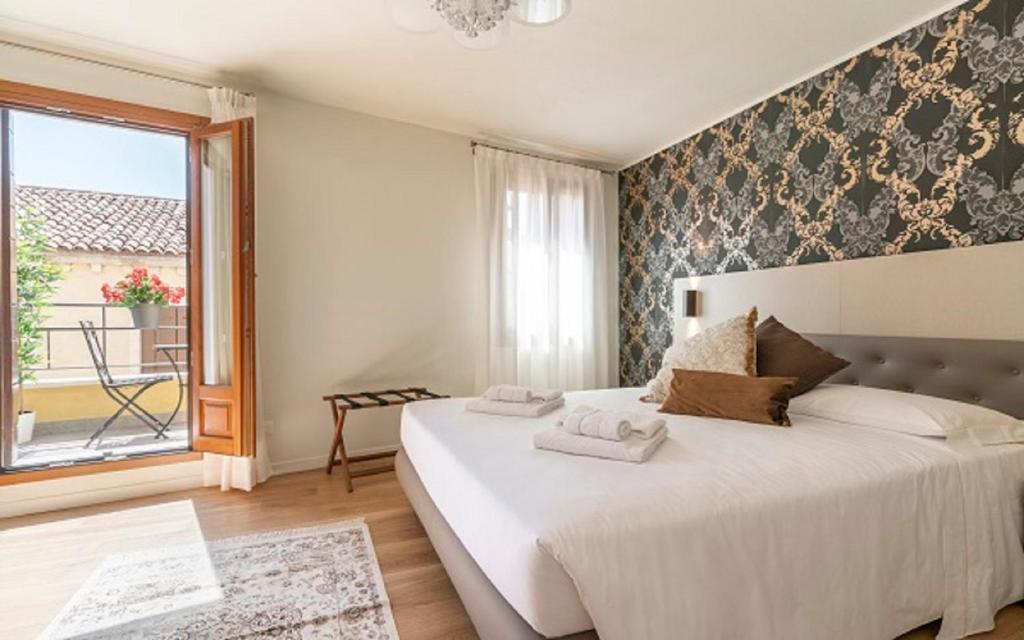 Postel nebo postele na pokoji v ubytování Hotel Grifoni