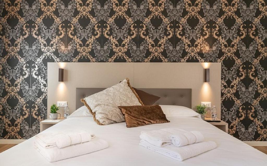 Postel nebo postele na pokoji v ubytování Hotel Grifoni