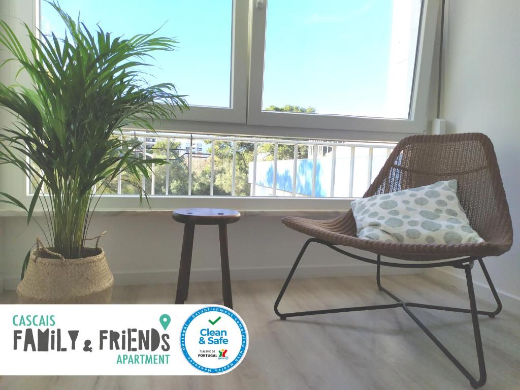 a chair and a plant in a room with a window at Cascais Family & Friends in Cascais