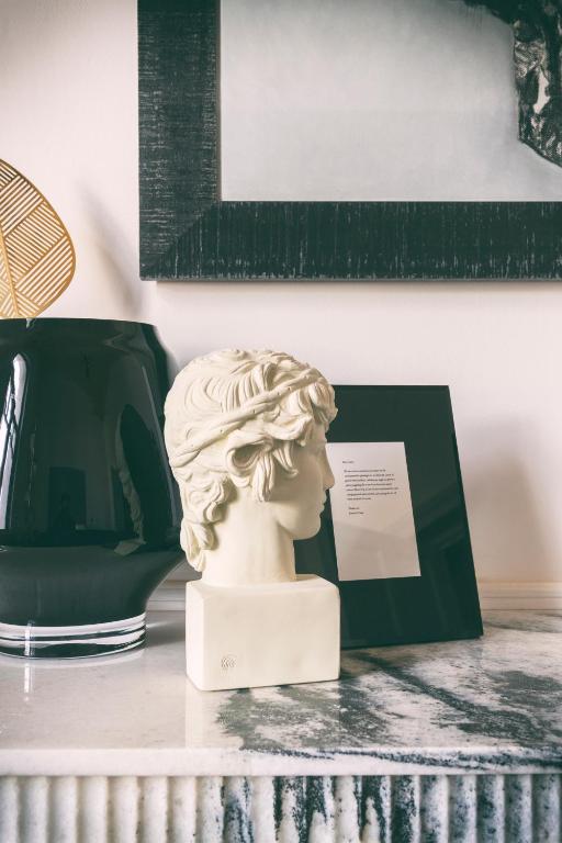 a bust of a woman sitting on a table at Aristide Hotel - Small Luxury Hotels of the World in Ermoupoli