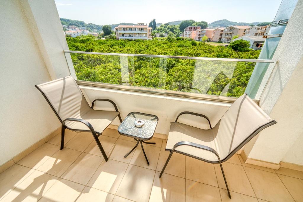 two chairs and a table in a balcony with a view at Boutique Hotel "Salina" in Ulcinj
