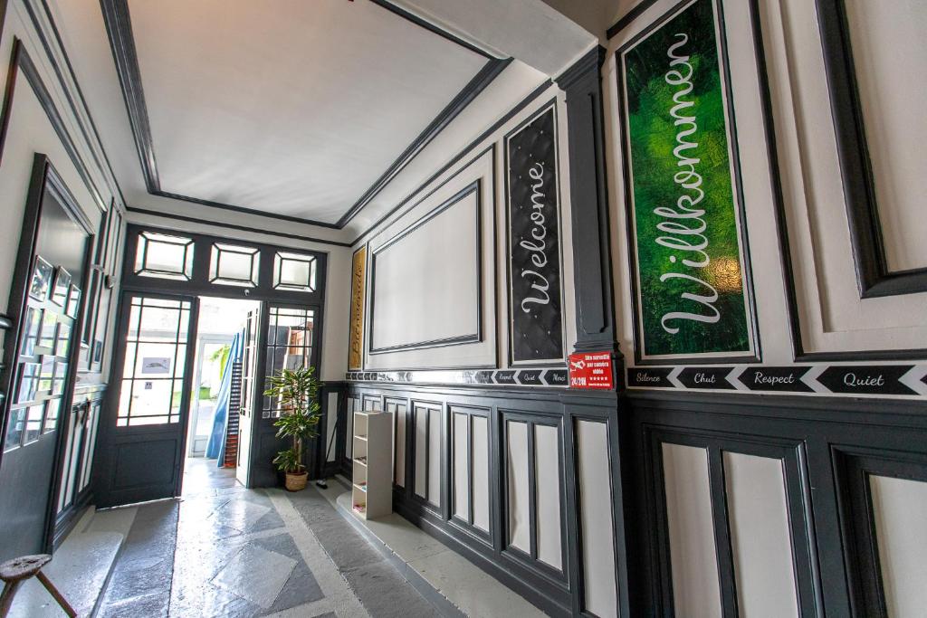 a hallway with a sign on the side of a building at Trankil'Apparts Centre in Saint-Quentin