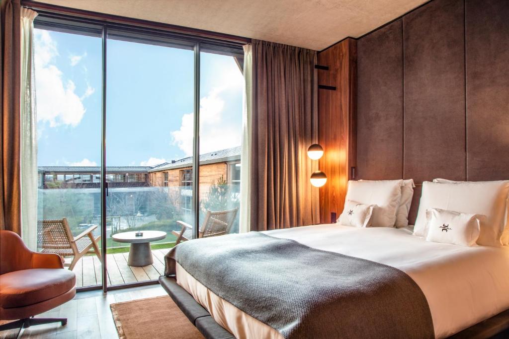 Postel nebo postele na pokoji v ubytování Jiva Hill Resort - Genève