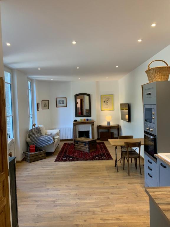 a living room with a kitchen and a table at CHEZ PAUL in Honfleur