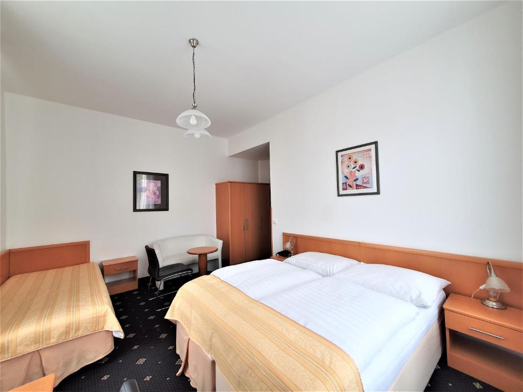 a hotel room with a bed and a desk at Máchova in Prague