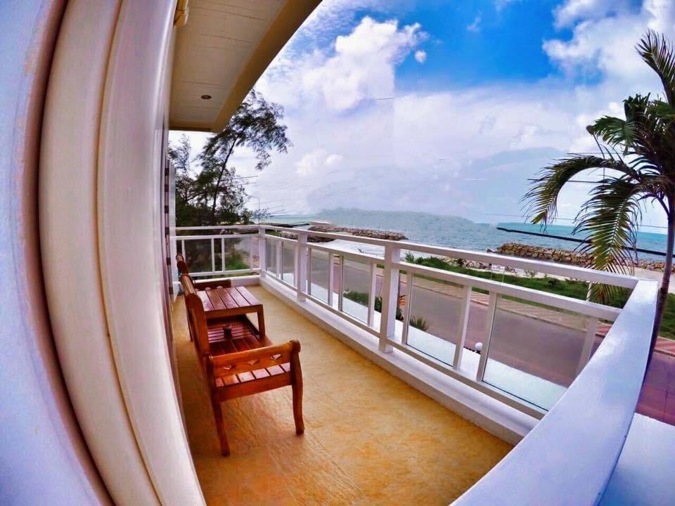 a balcony with a view of the ocean at PrivateRayong in Rayong
