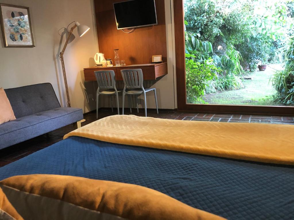 a hotel room with a bed and a large window at Rent apart Las Condes in Santiago