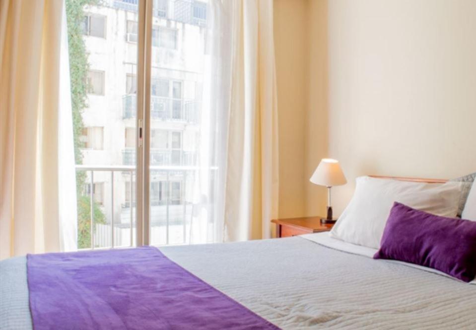 Cama o camas de una habitación en UH ApartHotel Lastarria