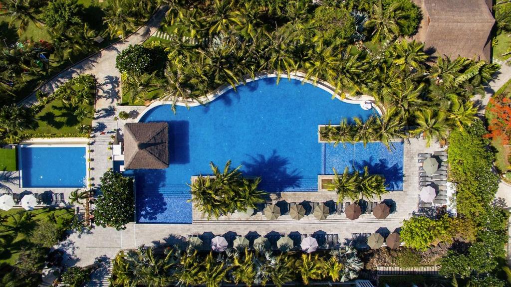 an overhead view of a pool with trees around it at Apartments Garden view in Cliff Resort & Residences in Mui Ne