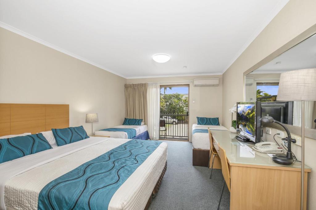 a hotel room with two beds and a television at Best Western Airport 85 Motel in Brisbane