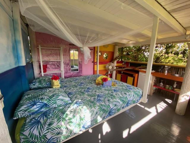 a bedroom with a large bed in a house at Gites titanse, la cabane dans l arbre in Cadet