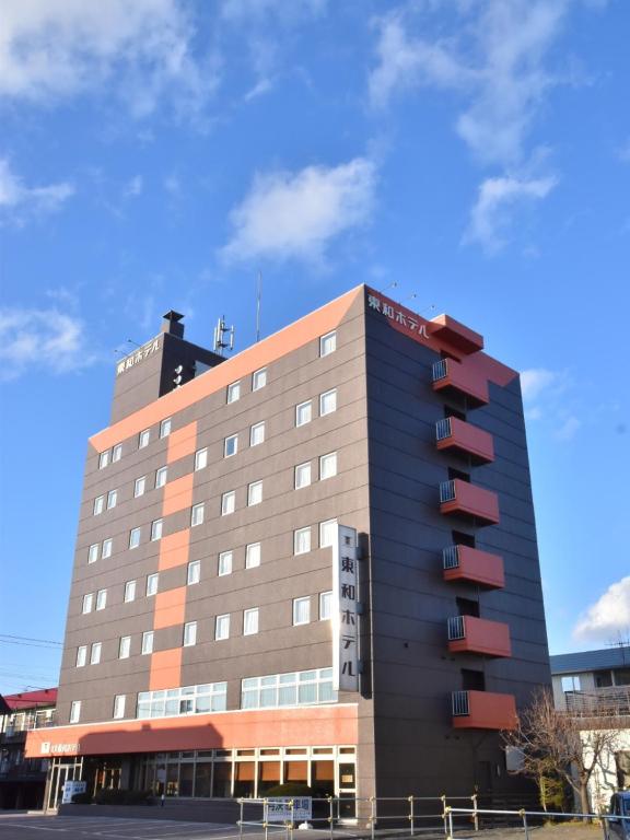 un edificio de hotel con un cielo azul en el fondo en Kitami Towa Hotel, en Kitami