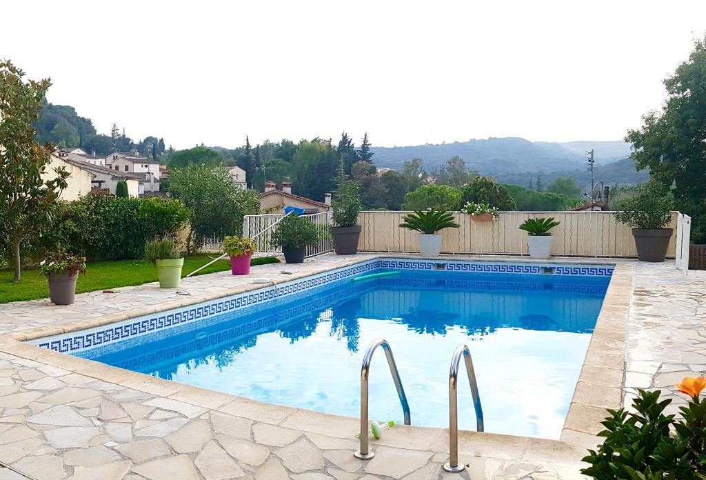 a swimming pool in the backyard of a house at Le Jacaranda in Villeneuve-Loubet