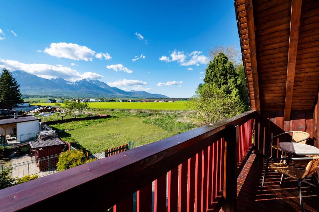 a balcony with a view of a field and mountains at FAIRYTAIL sk in Veľký Slavkov