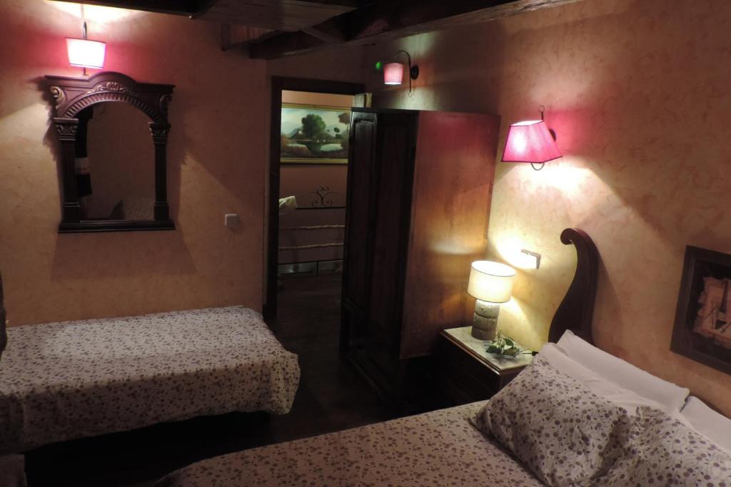 A bed or beds in a room at Posada Rural SPA Granja LA TEJERA de Lozoya