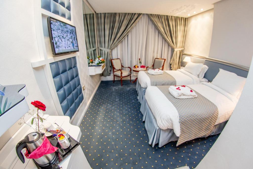 Postel nebo postele na pokoji v ubytování Montana Al Azizia Hotel