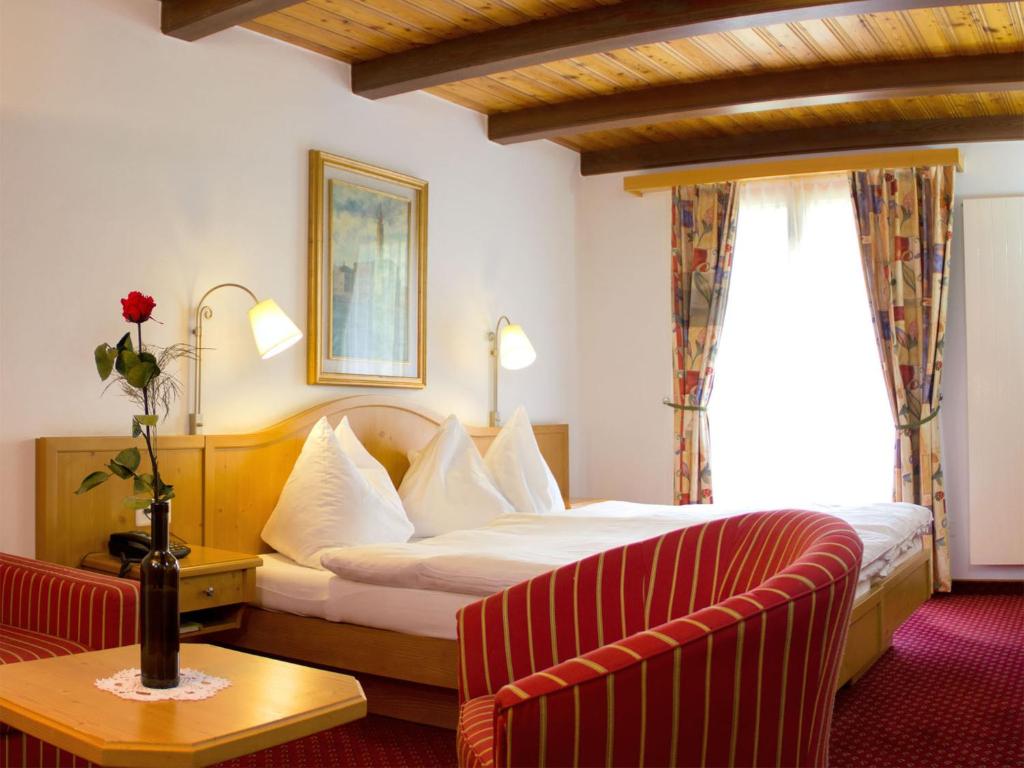 a hotel room with a bed and a couch at Alpenblick in Zermatt