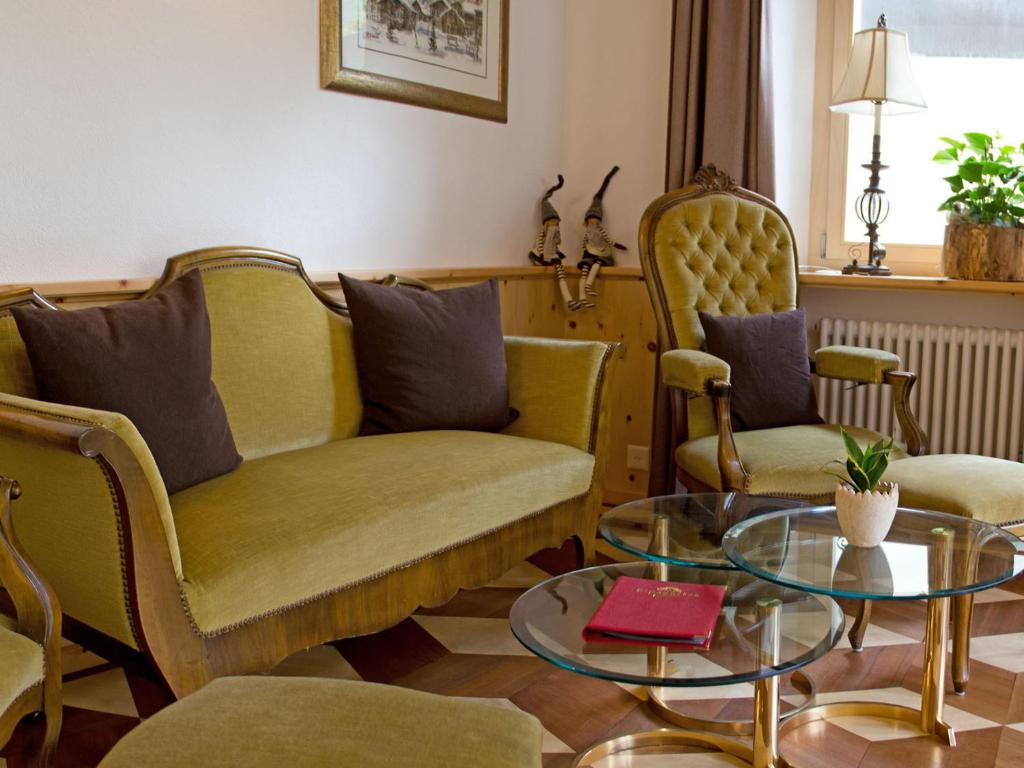 a living room with a couch and two chairs and a table at Alpenblick in Zermatt