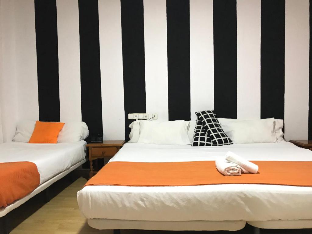 Postel nebo postele na pokoji v ubytování Hotel Argos