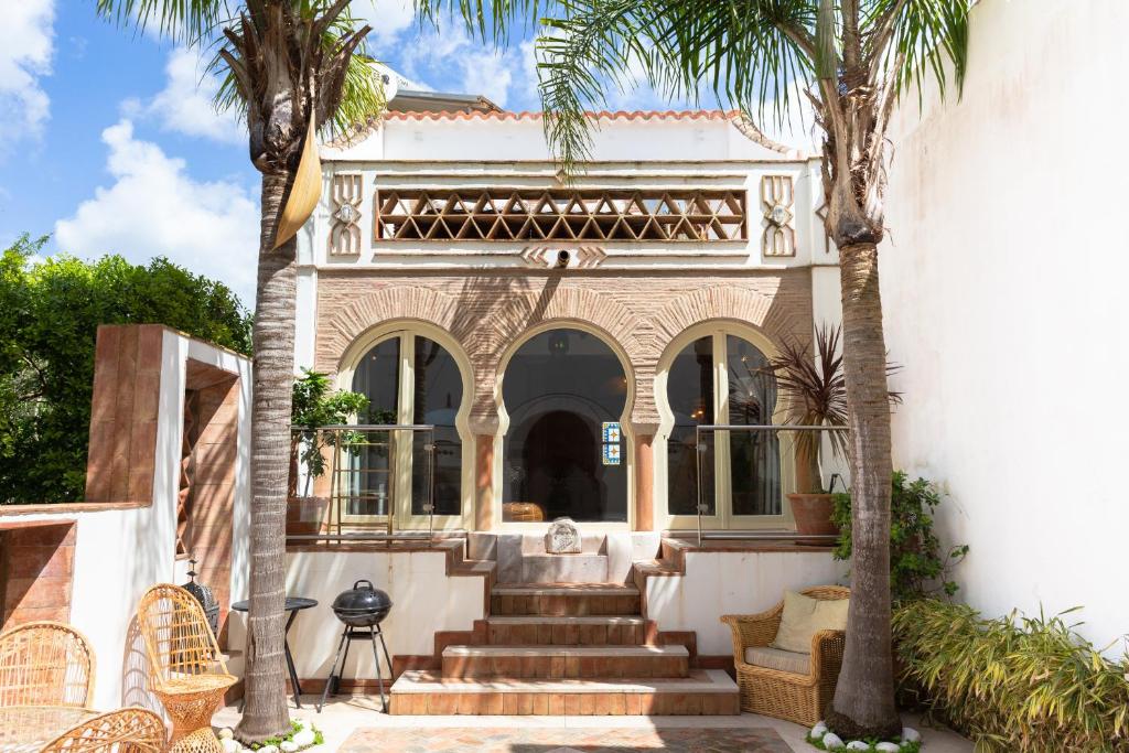 a house with palm trees in front of it at Beachhouse Algarve, Beach 50m in Salema