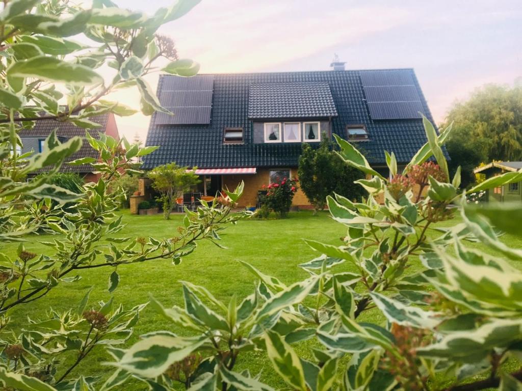 une maison avec des panneaux solaires sur son toit dans l'établissement Ferienwohnungen Stips, à Tönning