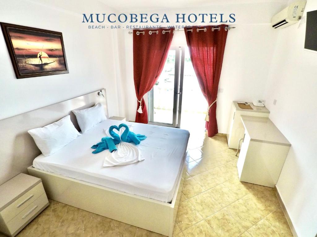 Postel nebo postele na pokoji v ubytování Mucobega Hotel