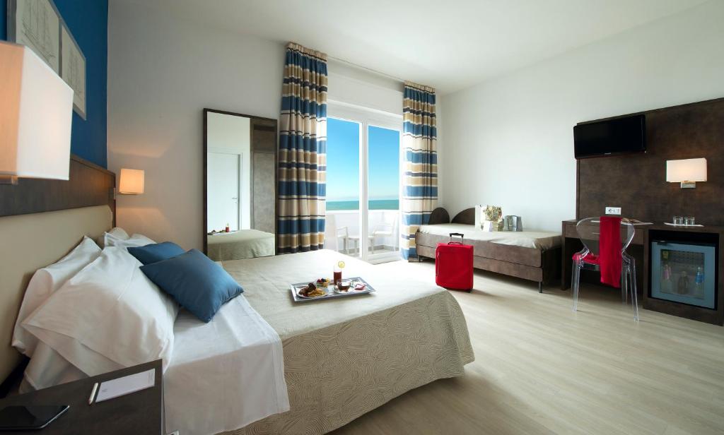 Postel nebo postele na pokoji v ubytování Hotel Giulia