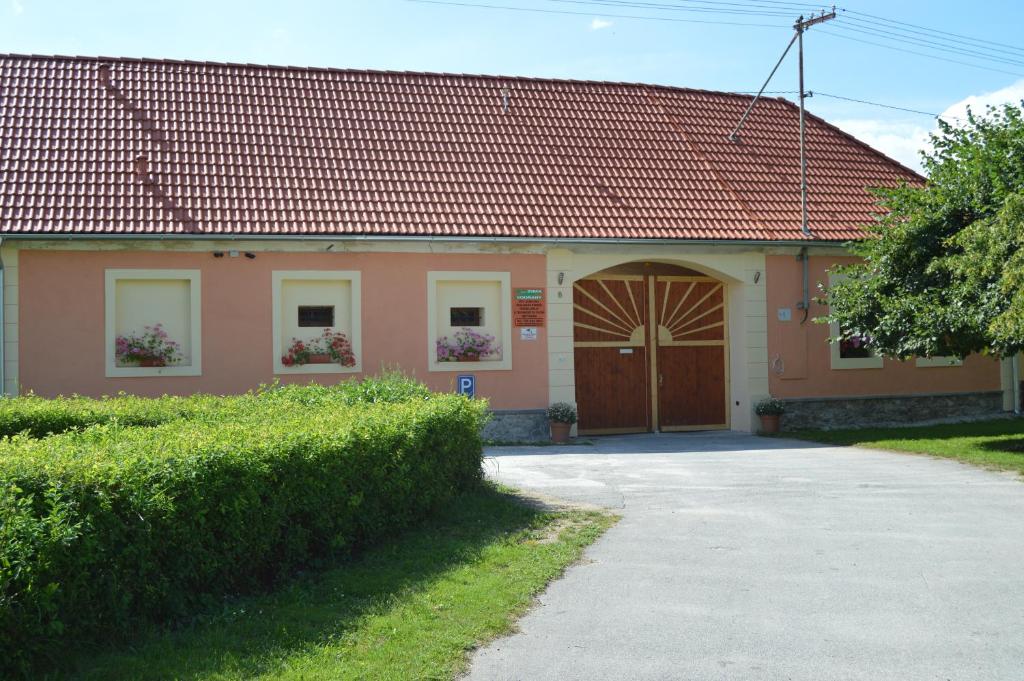 a house with a red roof and a garage at Ubytování U Zimů in Vodňany