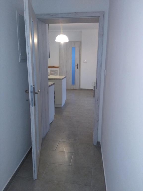 a hallway of a kitchen with a hallway leading to a room at Apartmán GUTINO in Česká Třebová