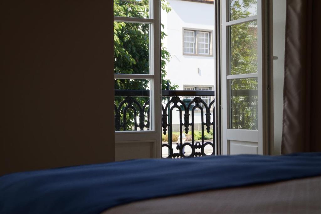 Postel nebo postele na pokoji v ubytování Angra Central Hotel