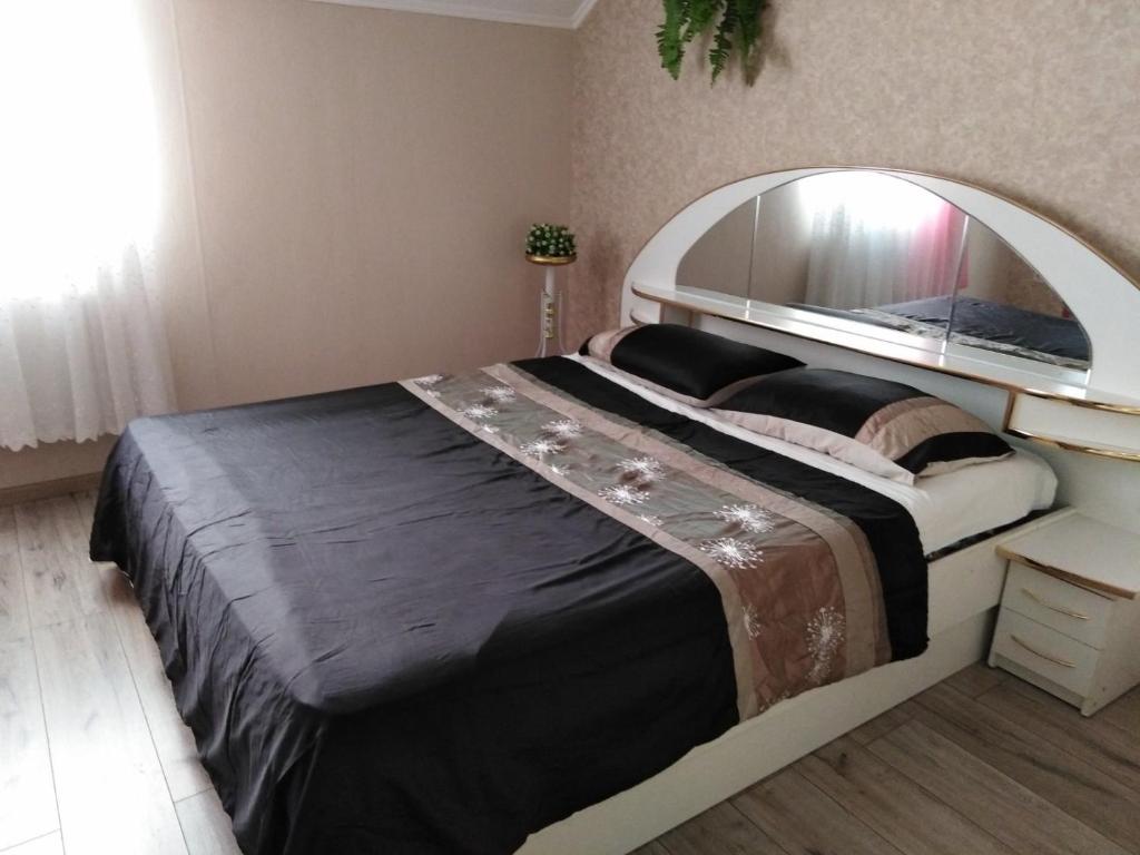 ein Schlafzimmer mit einem großen Bett und einem großen Spiegel in der Unterkunft Apartament on Komarova 29 вулиця Комарова 29 in Kropywnyzkyj