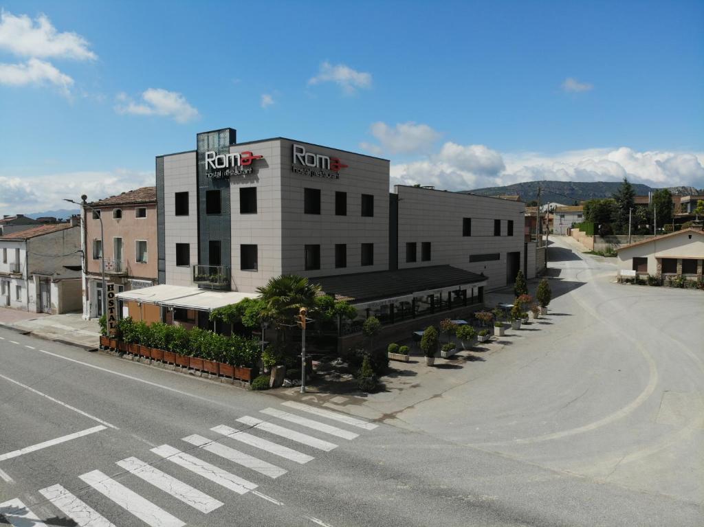 a building on the side of a street at Hostal Restaurant Roma in Cubells